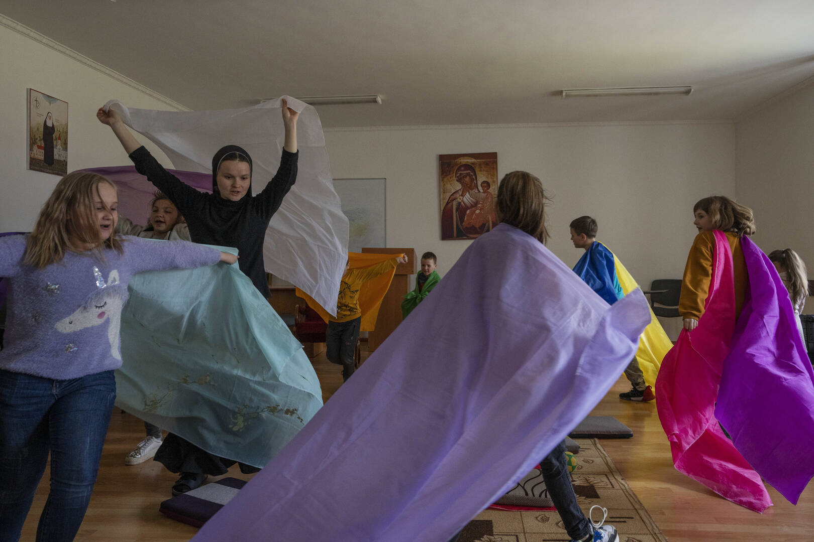 Nuns play with internally displaced children, who are taking refuge at the Hoshiv Women's Monastery, in Ivano-Frankivsk region, western Ukraine, Wednesday, April 6, 2022. (AP Photo/Nariman El-Mofty)