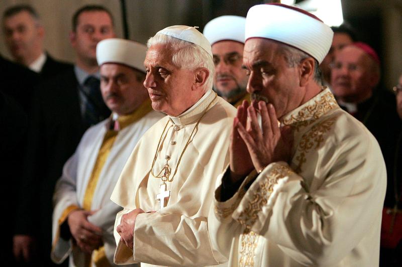 Benedict XVI in Blue Mosque (2): Pope Benedict XVI prays next to Mustafa Cagrici, right, the grand mufti of Istanbul, during a visit to the Blue Mosque in this Nov. 30, 2006, file photo. The pope's unexpected prayer in the mosque soothed anger in the Muslim world over a quote about Islam in his Sept. 12, 2006, lecture in Regensburg, Germany. (CNS photo/Patrick Hertzog, pool via EPA)