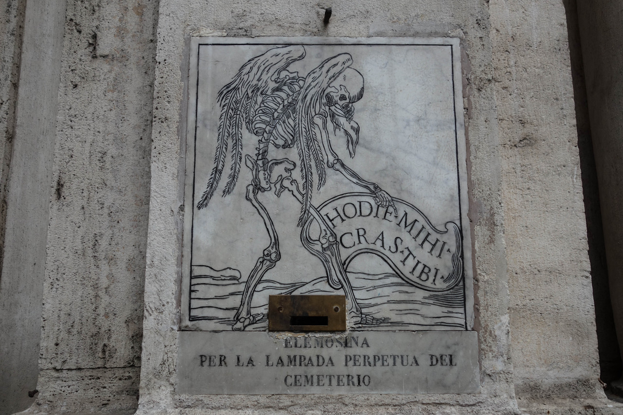 An engraving of a skeleton with feathered wings unfurling a banner: hodie mihi, cras tibi. “Today me, tomorrow you.” (Photo provided by author)