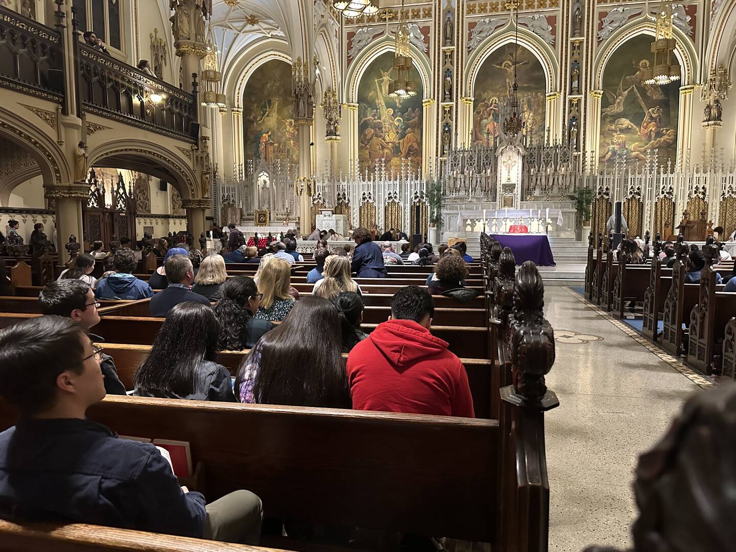 people sit in the church at catholic underground