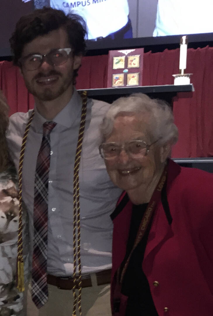 jesuitical host zac davis stands next to sister jean on zac's graduation day