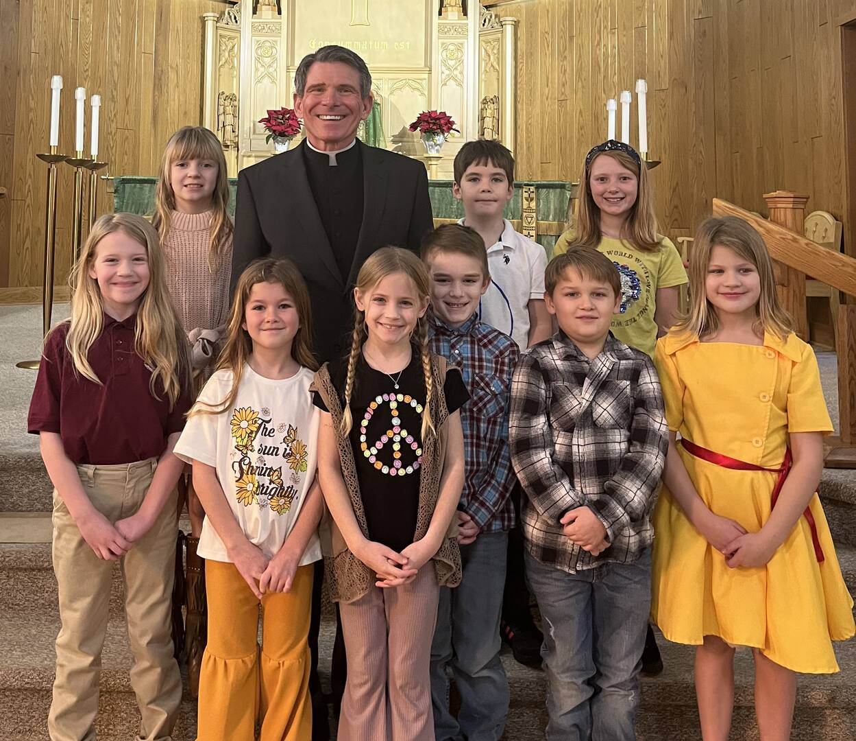 The Rev. Terrance Klein with second grade students who recently celebrated their first confession.