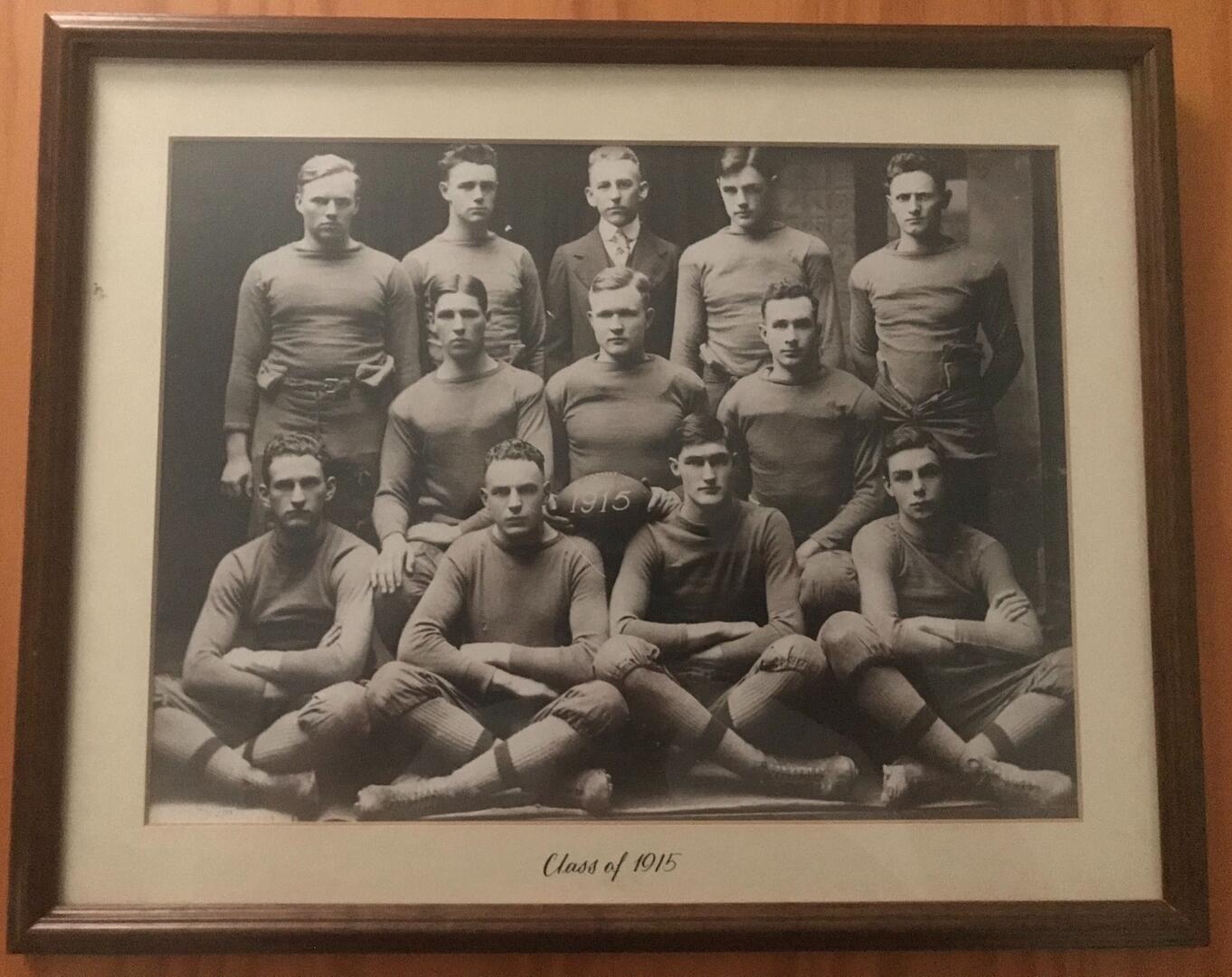 A framed, black-and-white photograph of an early 20th-century youth football team from the 1989 film “Dead Poets Society” (Photo provided by author)