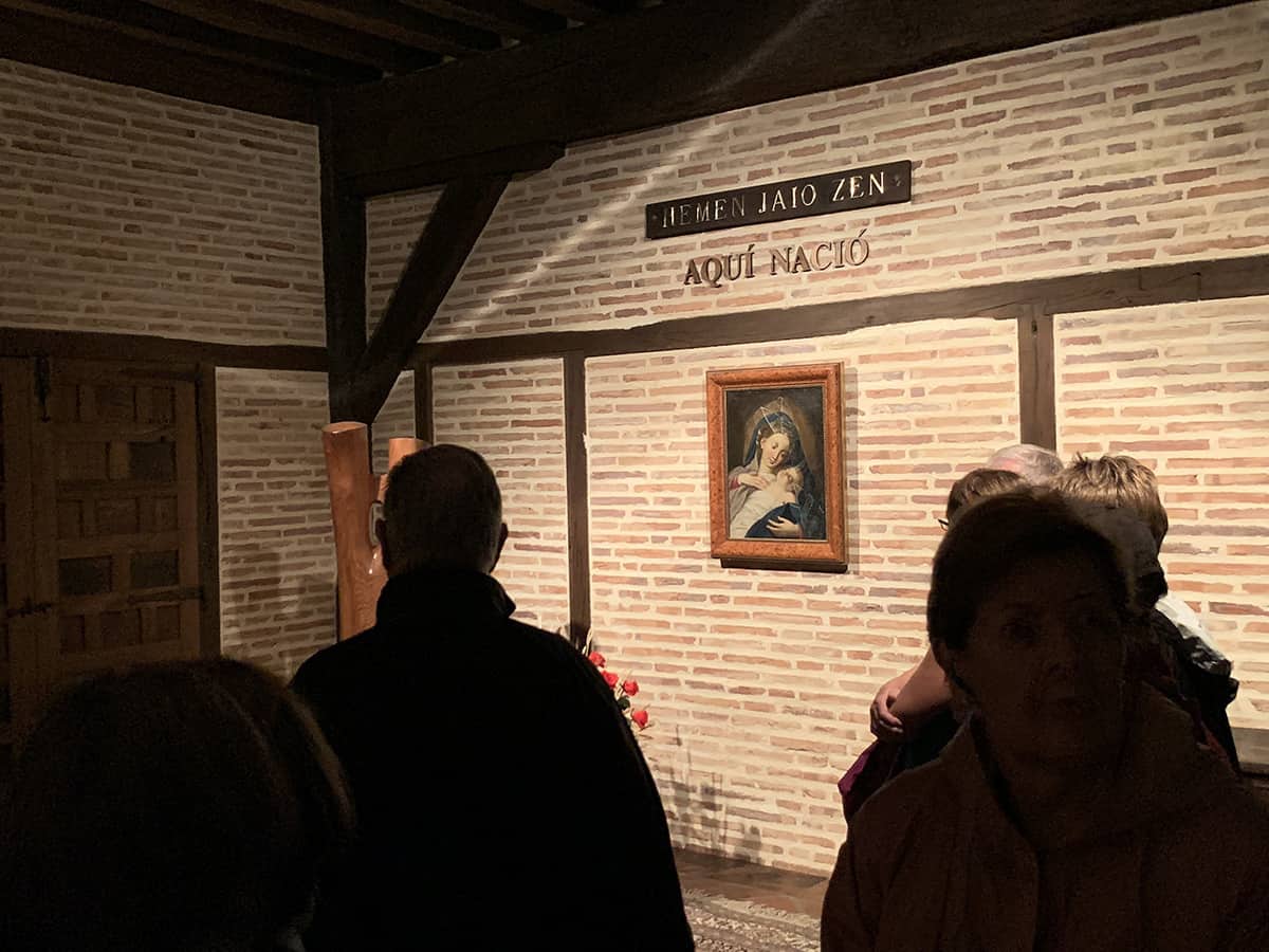 Pilgrims pause to pray and reflect in the room where St. Ignatius was born