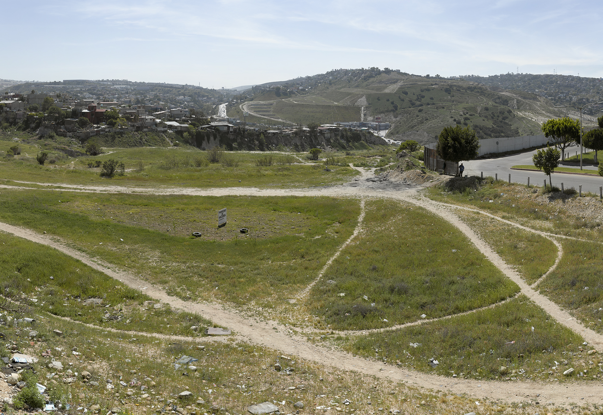 Tijuana residents have worn paths through a vacant patch of grass in this border city. (David Taylor)