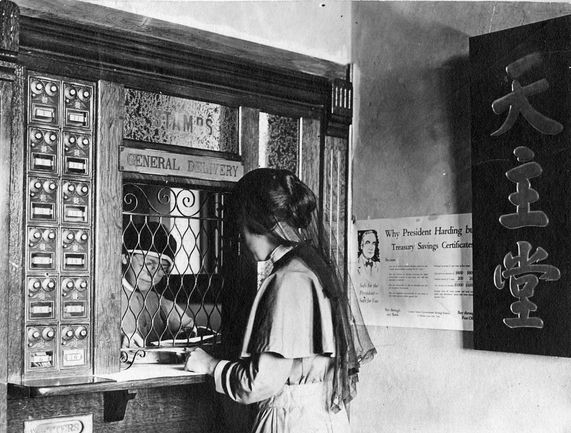 Sister Katherine Slattery, MM, serves a customer at the Maryknoll Post Office, c. 1920s. (Maryknoll Mission Archives)