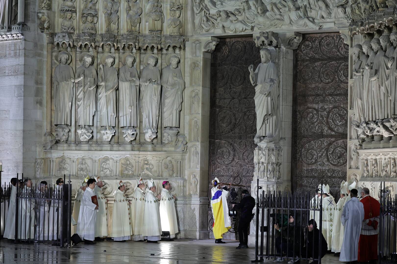 Archbishop Laurent Ulrich of Paris inaugurates the reopening of Notre-Dame de Paris by knocking on the doors with his pastoral staff, or crosier, on Dec. 7, 2024 (OSV News photo/Christophe Petit Tesson, Reuters)