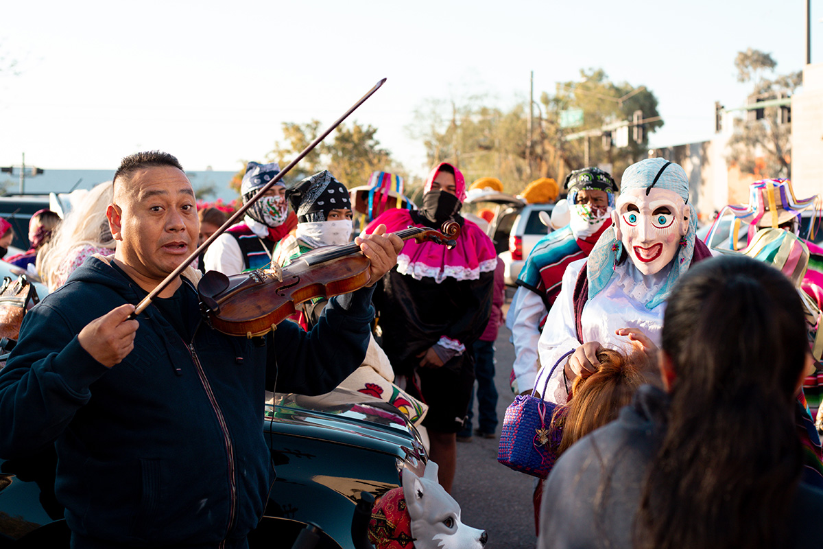 A violinist prepares for the Honor Your Mother festival in Phoenix, Ariz. on December 4, 2021.
