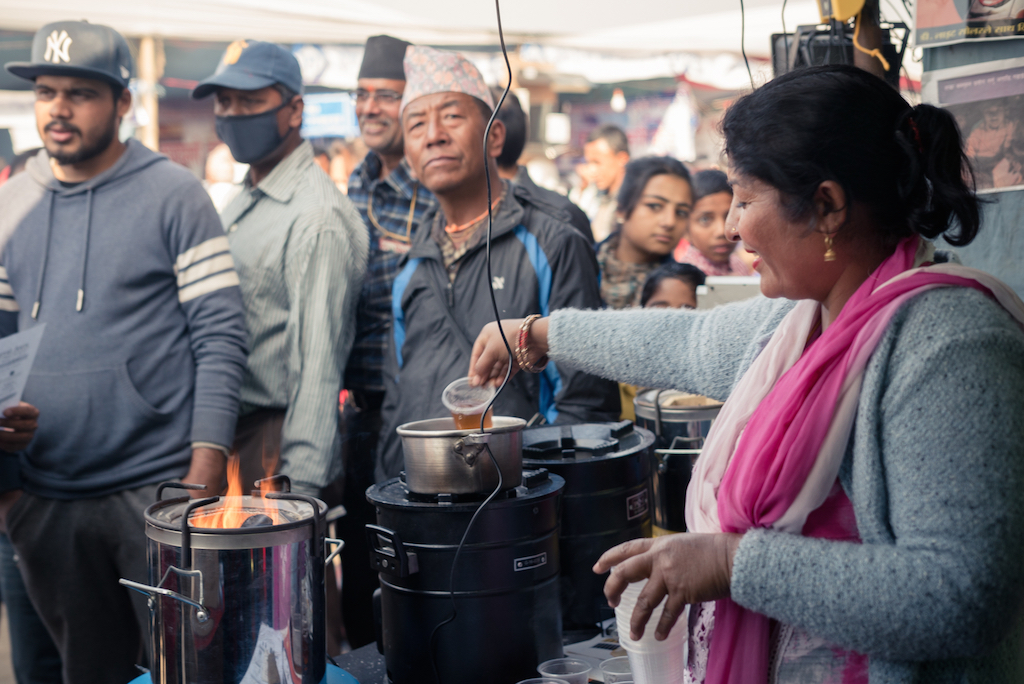 Laxmi Neupane, CEO of Manakamana Saurya Urjah, gives a cooking demonstration with a clean cookstove, a new product women in Empower Generation’s distribution network are selling. (Courtesy of Empower Generation)