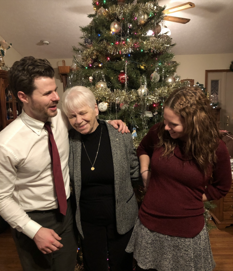 Author in front of a Christmas tree with his sister and grandmother