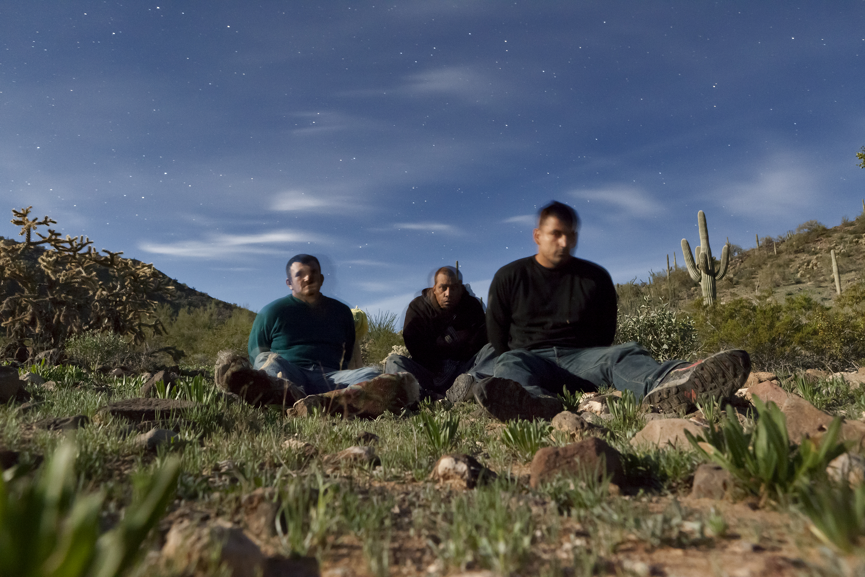 Three migrants apprehended by border patrol posed for this 30-second exposure. (David Taylor) 