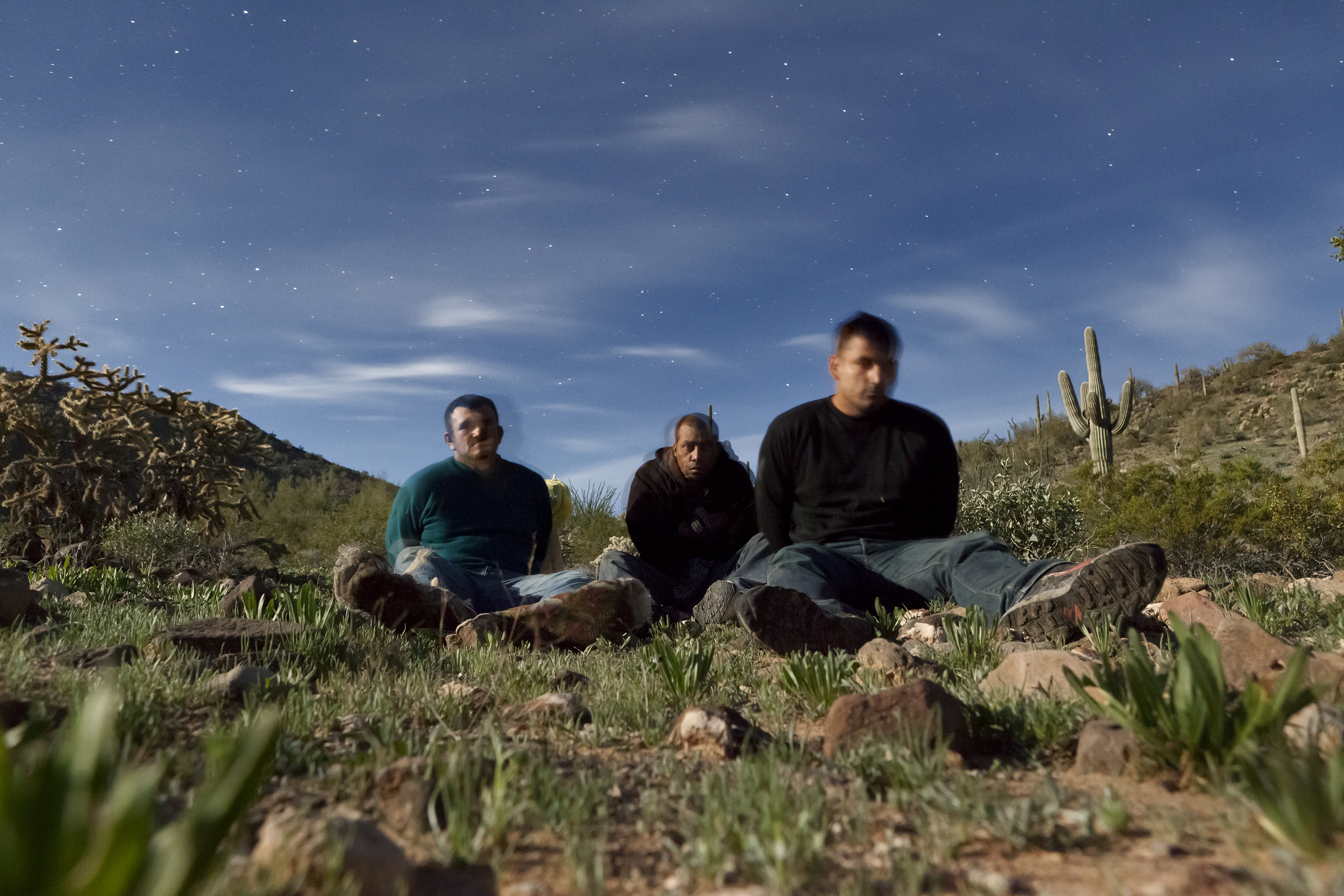 Three migrants apprehended by border patrol posed for this 30-second exposure. (David Taylor)