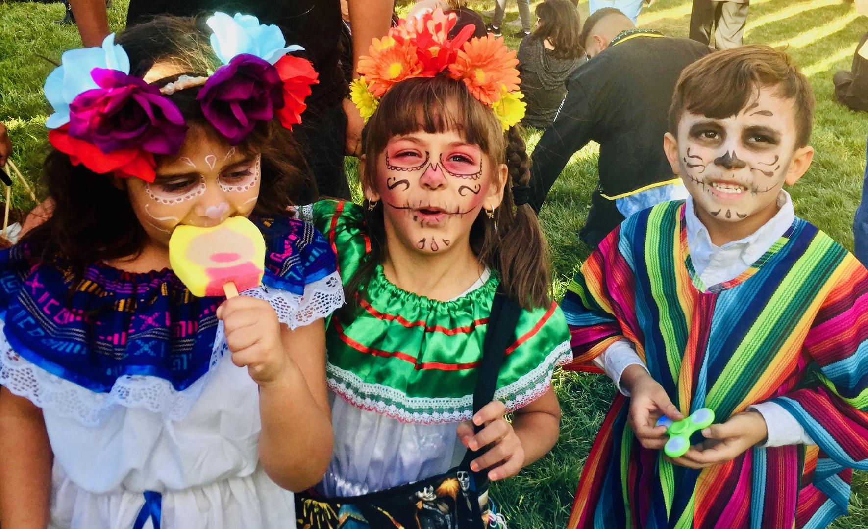 Young girls dressed as skeletons at the ‘Muertos y Marigolds’ parade in Albuquerque, N.M. (Credit: Sonja Livingston) 