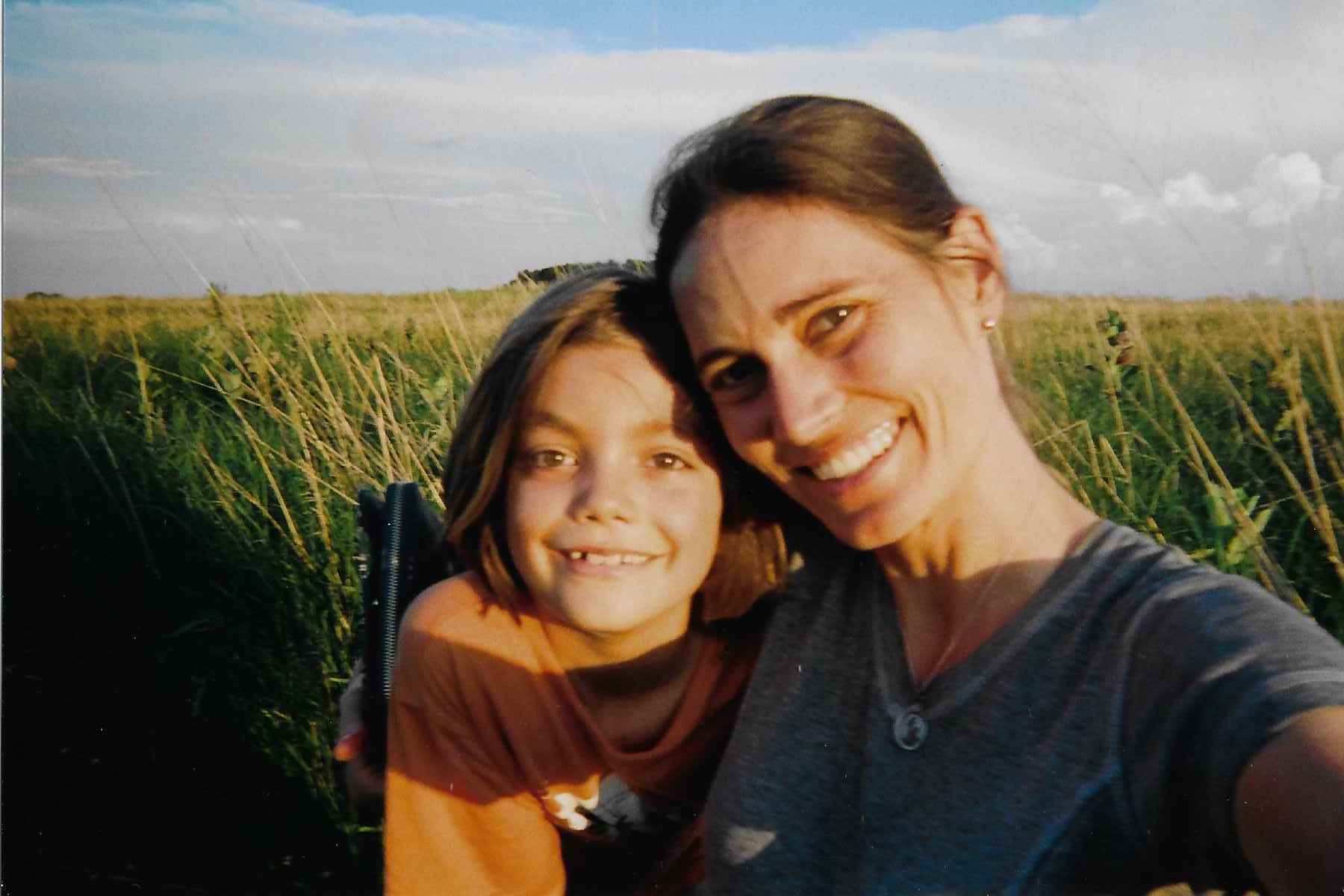 Enjoying the sunset in a man's dream of turning his hayfield into a recreation of a dugout and a sodhouse with native prairie grasses in Sanborn, MN