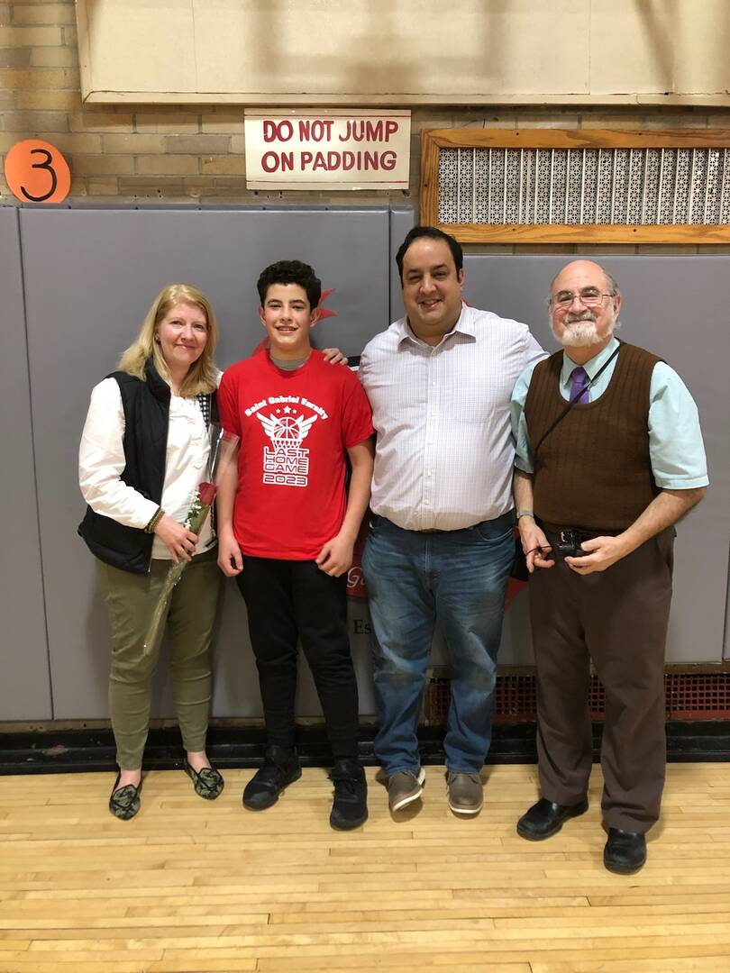 The author's extended family is pictured in the gym of St. Gabriel’s School with longtime teacher Mr. Glenn McCarthy.