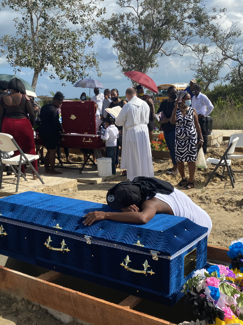 A grief-stricken teenager throws himself onto his grandma’s casket (Photo by author)