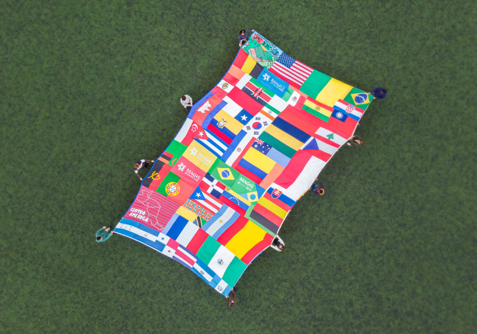 A quilt featuring some of the MAGIS logos over the years, and the flags of all the countries who have participated in MAGIS since it first started in 2005. Photo credit: MAGIS 2023