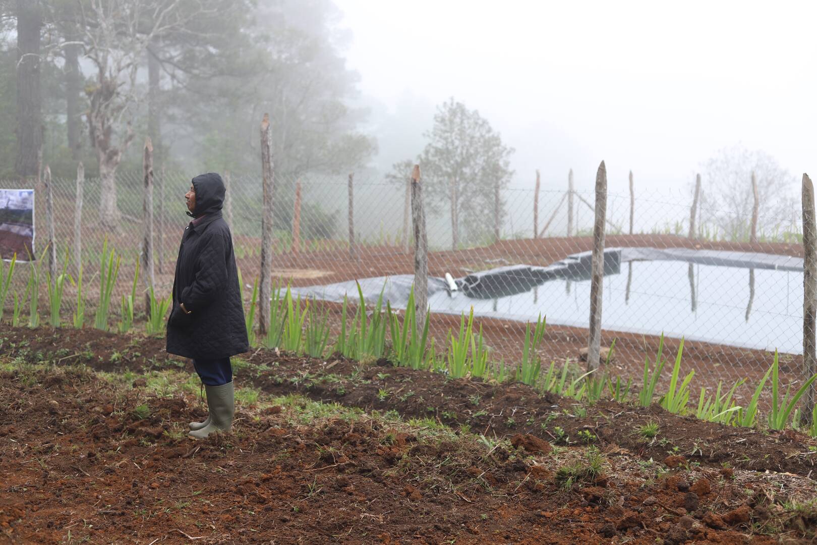 A farmer stands by a reservoir in Honduras