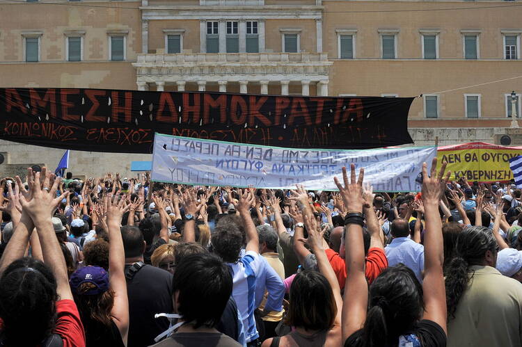 Anti-austerity demonstration in front of the Greek parliament (Photo via Wikimedia)