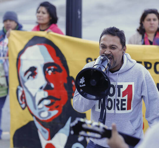 Tomas Martinez shouts into a megaphone during an immigration reform rally at the Atlanta City Detention Center in Atlanta Nov. 21. The year 2014 brought potentially significant changes for millions of people who are in the United States illegally. (CNS/EPA)