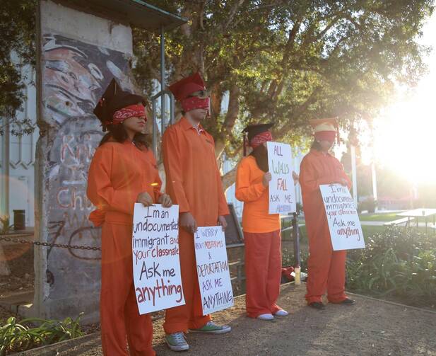 Undocumented students at Loyola Marymount University demonstrate on campus in front of a piece of the Berlin Wall shortly before the 2016 presidential election. (Photo by Antonio De Loera-Brust) 