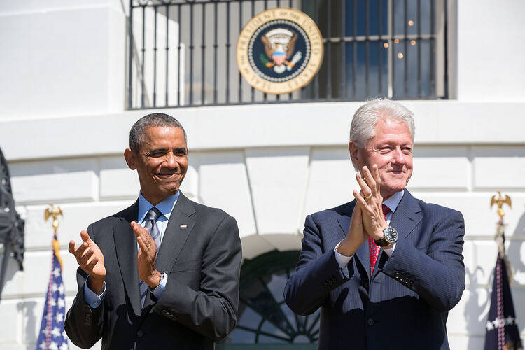 President Barack Obama and former President Bill Clinton applaud during the 20th anniversary of the AmeriCorps national service program on the South Lawn of the White House, Sept. 12, 2014. (Official White House Photo by Pete Souza)