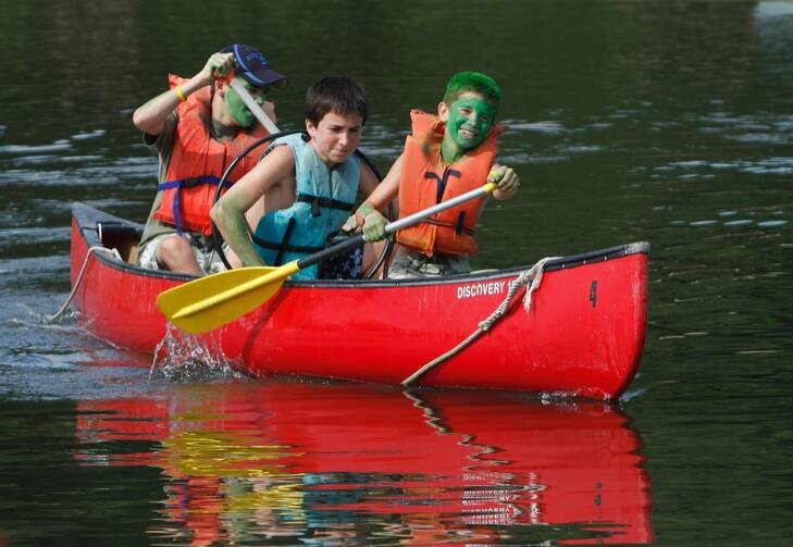 Boys compete in a canoe event at Camp Alvernia in Centerport, N.Y., the longest-running Catholic summer camp in the country. (CNS photo/Gregory A. Shemitz, Long Island Catholic)