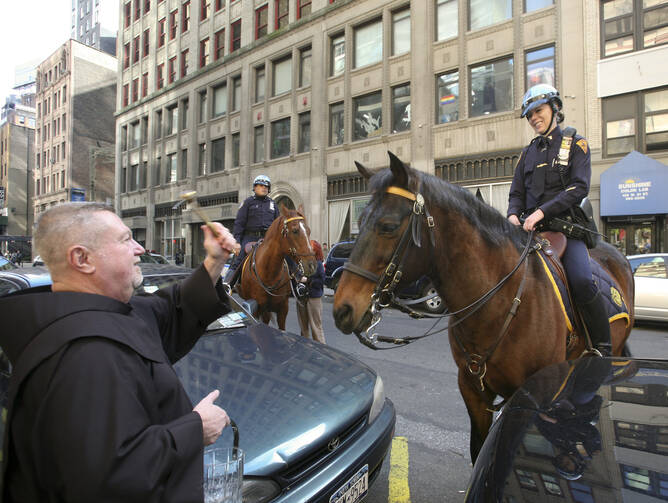 A priest blesses a New York City police officer's horse on the feast of St. Francis of Assisi, patron saint of animals. (CNS photo/Octavio Duran)