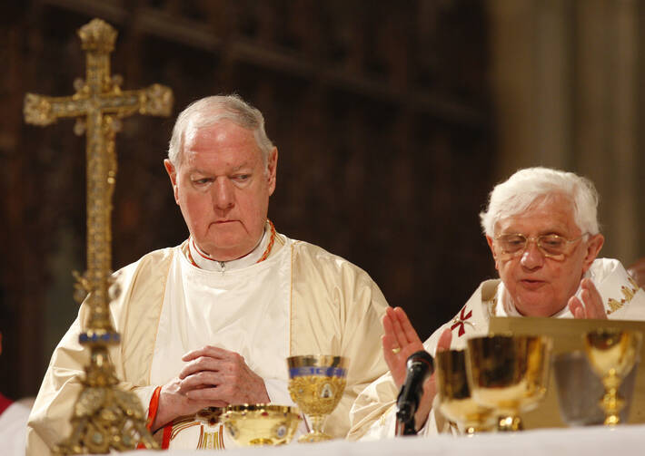 Cardinal Edward M. Egan joins Pope Benedict XVI at the altar during Mass at St. Patrick's Cathedral in New York April 19 during the pope's 2008 U.S. visit. (CNS photo/Nancy Wiechec)