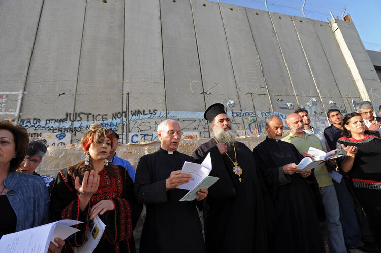 Christian leaders pray in front of the Israeli separation wall near Rachel's Tomb in Bethlehem, West Bank, May 29, the beginning of the 2010 World Week for Peace in Palestine and Israel. (CNS photo/Debbie Hill) 