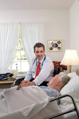 Doctor Talks with Senior Patient at Ohio Home. (CNS photo/Matthew Barrick)