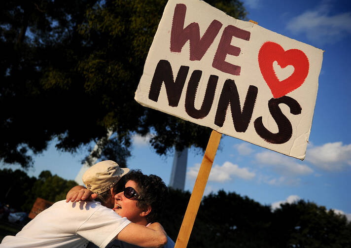 A Dominican sister and novice embrace prior to a rally by laity and religious in support of nuns gathered at the 2012 assembly of the Leadership Conference of Women Religious. ((CNS photo/Sid Hastings) 