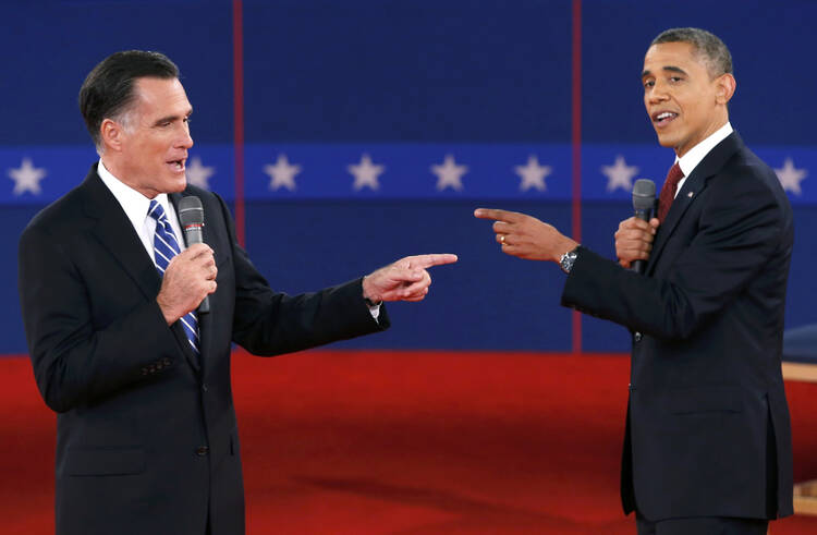 Republican Mitt Romney and Democrat Barack Obama each point out the country's biggest problem during a 2012 presidential debate. (CNS photo/Mike Segar, Reuters)