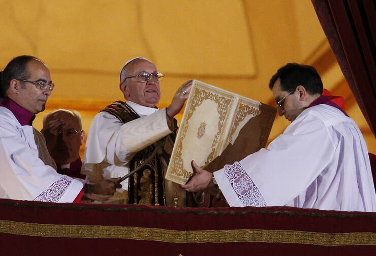 Pope Francis I delivers his first blessing from the central balcony of St. Peter's Basilica at the Vatican on March 13, 2013. Cardinal Jorge Mario Bergoglio of Argentina was elected the 266th Roman Catholic pontiff. (CNS photo/Paul Haring)