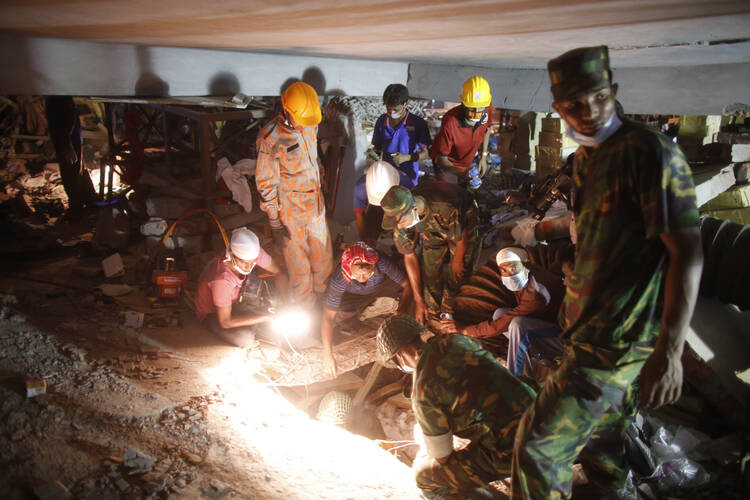 Rescue workers look for trapped garment workers at the collapsed Rana Plaza building in Bangladesh (CNS photo/Andrew Biraj, Reuters)