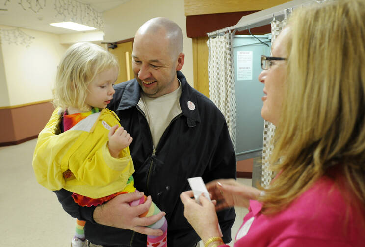 Census data suggest that people in more stable economic and living situations are more likely to vote. (CNS photo/Mike Crupi, Catholic Courier) 