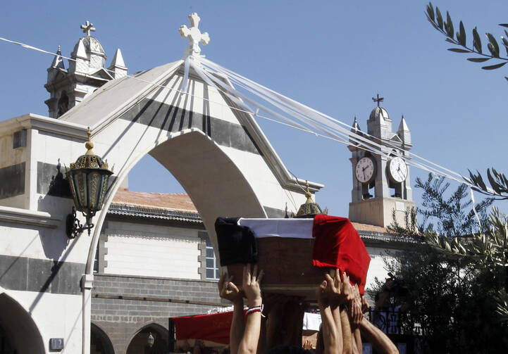 Mourners carry coffins of Christian men killed during raid in Syria (CNS photo/Khaled al-Hariri, Reuters)