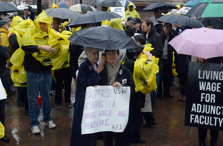 Rae O’Hair, left, a Duquesne University alumna, and her friend Daniele Orosz rally for unionizing adjunct faculty in December 2013.