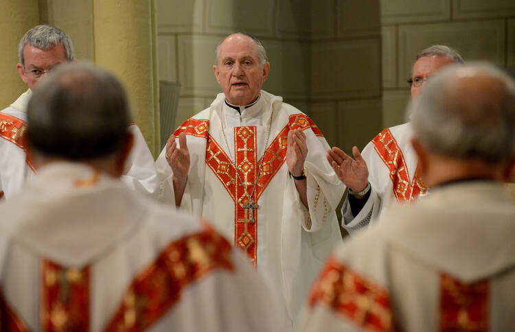 Bishop Pates prays during Mass of Thanksgiving for 50 years of Catholic Relief Services' presence in Holy Land. (CNS photo/Debbie Hill)