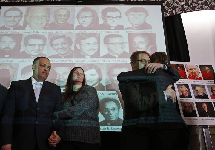 Carmen Severino, an abuse survivor, is embraced during a news conference that heralded the release of thousands of documents from the Chicago Archdiocese on past cases of clergy sexual abuse in January 2014. (CNS photo/Jim Young, Reuters)