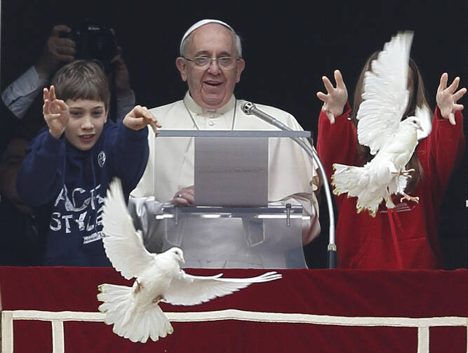 The two young people at Pope Francis' side launched doves to highlight the church's call for peace in the world. (CNS photo/Paul Haring)