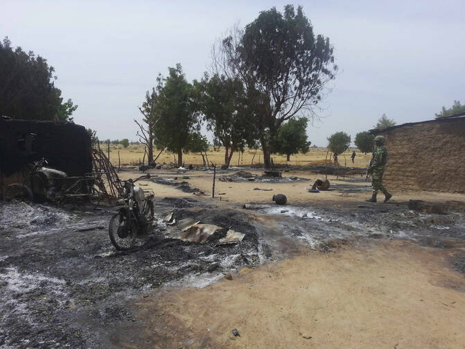 Soldiers stand guard following an attack in Nigeria. (CNS photo/Reuters)