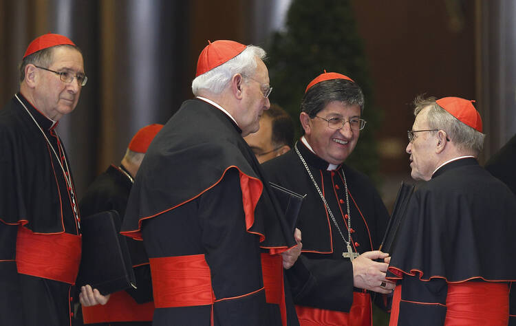 German Cardinal Kasper and other cardinals speak as they arrive for meeting with Pope Francis in synod hall at Vatican. (CNS photo/Paul Haring)