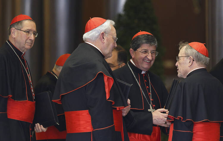 German Cardinal Kasper and other cardinals speak as they arrive for meeting with Pope Francis in synod hall at Vatican. (CNS photo/Paul Haring)