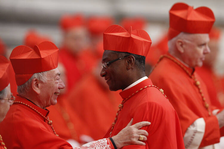 Italian Cardinal Coccopalmerio greets new Cardinal Langlois of Les Cayes, Haiti, during consistory at Vatican. (CNS photo/Paul Haring)