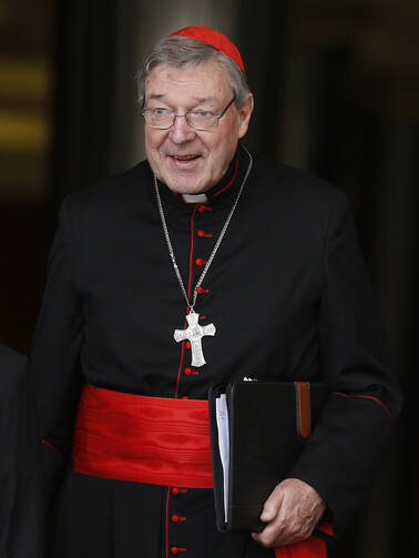 Cardinal Pell of Sydney leaves meeting of cardinals with Pope Francis in synod hall at Vatican. (CNS photo/Paul Haring)