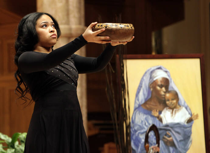 Renisha Malik carries incense in the opening procession of a Feb. 26 service celebrating the annual African-American Heritage Month at Holy Name Cathedral in Chicago. (CNS photo/Karen Callaway, Catholic New World)