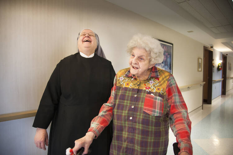 Sister Jean Dwyan laughs with a resident at the St. Louis Residence of the Little Sisters of the Poor in January 2014. (CNS photo/Lisa Johnston, St. Louis Review)