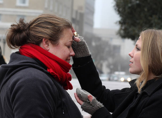 Woman receives ashes from street chaplain on Ash Wednesday in Tennessee. (CNS photo/Kathleen Barry, UMNS)