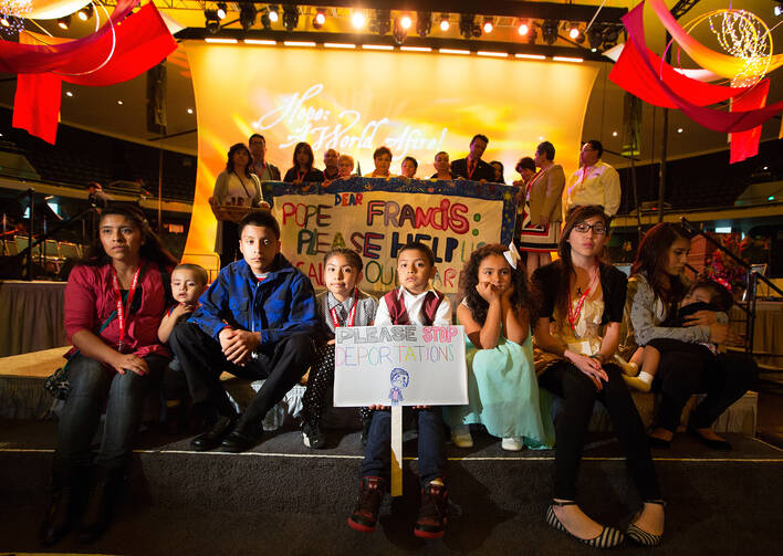 Boy at Religious Education Congress in California displays sign calling for end to deportations. (CNS photo/Vict or Aleman, Via Nueva)